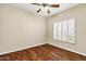 Bright bedroom with ceiling fan, wood floors, and plantation shutters for optimal light control at 1975 E Chilton Dr, Tempe, AZ 85283