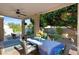 Covered patio with dining table, chairs, ceiling fan and view of the pool and lush greenery at 1975 E Chilton Dr, Tempe, AZ 85283