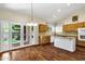 Well-lit kitchen with wooden cabinets, granite counters, and french doors at 1975 E Chilton Dr, Tempe, AZ 85283