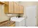 A tidy laundry room features ample cabinet space and modern, full-size washer and dryer units at 1975 E Chilton Dr, Tempe, AZ 85283