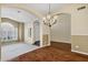 Open concept living room with decorative chandelier and an arched doorway at 1975 E Chilton Dr, Tempe, AZ 85283