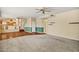 Open concept living room with half painted walls, plush carpeting, and easy access to the kitchen at 1975 E Chilton Dr, Tempe, AZ 85283