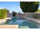 Private backyard featuring a refreshing pool surrounded by mature trees, shrubs and block wall at 1975 E Chilton Dr, Tempe, AZ 85283