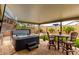Covered patio featuring a hot tub, television, and outdoor seating, perfect for relaxation and entertainment at 19858 W San Juan Ave, Litchfield Park, AZ 85340