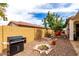 Grill in low maintenance backyard with rock landscaping, privacy walls and mature landscaping at 19858 W San Juan Ave, Litchfield Park, AZ 85340