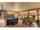 Covered patio featuring a hot tub, television, and outdoor seating, perfect for relaxation and entertainment at 19858 W San Juan Ave, Litchfield Park, AZ 85340
