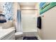 Bathroom with a toilet, a shower with a curtain and a boat themed artwork on the wall at 19858 W San Juan Ave, Litchfield Park, AZ 85340