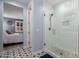 Bright bathroom with walk-in closet, bedroom view, and tile and glass enclosed shower at 19858 W San Juan Ave, Litchfield Park, AZ 85340