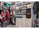 Well-organized walk-in closet with shelves, drawers, and hanging storage at 19858 W San Juan Ave, Litchfield Park, AZ 85340