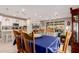 Dining room with a wooden table with seating for six with access to a modern kitchen and a sunroom at 19858 W San Juan Ave, Litchfield Park, AZ 85340