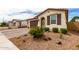 Stylish single Gathering home showing a brick driveway and desert landscaping with an ornamental front door at 19858 W San Juan Ave, Litchfield Park, AZ 85340