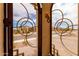 Close-up of front door featuring decorative steel and landscaped yard at 19858 W San Juan Ave, Litchfield Park, AZ 85340