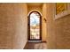 Exterior shot showcasing the decorative steel entry gate with stone surround at 19858 W San Juan Ave, Litchfield Park, AZ 85340