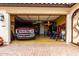 Spacious three car garage with car parked inside and lots of extra space at 19858 W San Juan Ave, Litchfield Park, AZ 85340