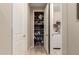 Hallway closet with ample space for storage and a laundry room with washer and dryer in the background at 19858 W San Juan Ave, Litchfield Park, AZ 85340