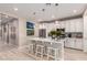 Well-lit kitchen with a quartz island, stainless steel appliances, and attractive pendant lighting at 19858 W San Juan Ave, Litchfield Park, AZ 85340