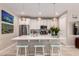 Bright kitchen featuring a quartz island, stylish pendant lights, and stainless steel appliances at 19858 W San Juan Ave, Litchfield Park, AZ 85340