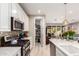 Modern kitchen has white cabinetry, stainless steel appliances, and access to an open pantry at 19858 W San Juan Ave, Litchfield Park, AZ 85340
