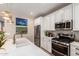 This kitchen features a quartz island with a farmhouse sink, stainless steel appliances, and decorative pendant lighting at 19858 W San Juan Ave, Litchfield Park, AZ 85340