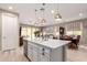 Modern kitchen featuring a quartz island with seating, sink and stainless steel appliances at 19858 W San Juan Ave, Litchfield Park, AZ 85340