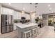 Modern kitchen with white cabinetry, a quartz island, pendant lighting, and stainless steel appliances at 19858 W San Juan Ave, Litchfield Park, AZ 85340