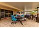 Relax on this covered patio, complete with a fire pit table and a soothing hot tub for ultimate outdoor enjoyment at 19858 W San Juan Ave, Litchfield Park, AZ 85340