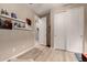 Spare bedroom with open door and sliding door closet with shelves and pet supplies at 19858 W San Juan Ave, Litchfield Park, AZ 85340