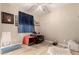 A room with a ceiling fan and a window with a blue curtain and a pet carrier and pet bowls on the floor at 19858 W San Juan Ave, Litchfield Park, AZ 85340