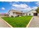 Expansive backyard showcasing a well-maintained lawn and covered patio, ideal for outdoor entertaining at 2242 E Palm Ln, Phoenix, AZ 85006