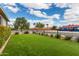 View of artificial turf backyard, enclosed by a sleek black fence, offering a secure and low-maintenance outdoor space at 2242 E Palm Ln, Phoenix, AZ 85006