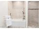Bright bathroom featuring a tiled shower and tub, along with neutral fixtures and hardware at 2242 E Palm Ln, Phoenix, AZ 85006