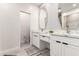 Bright bathroom with dual sinks, modern fixtures, white cabinets, and elegant countertops at 2242 E Palm Ln, Phoenix, AZ 85006