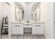 Modern bathroom with double vanity, sleek mirrors, stylish fixtures, and linen cabinet at 2242 E Palm Ln, Phoenix, AZ 85006