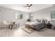 Stylish bedroom featuring a beautifully made bed, modern lighting, and ample natural light from the windows at 2242 E Palm Ln, Phoenix, AZ 85006