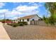 A cozy one-story home surrounded by a beautiful gravel landscape with lush greenery at 2242 E Palm Ln, Phoenix, AZ 85006
