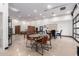 Spacious garage featuring a foosball table, dining table, and an abundance of lighting at 2242 E Palm Ln, Phoenix, AZ 85006