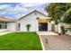 Charming home featuring a glass garage door and covered carport area for convenient parking and curb appeal at 2242 E Palm Ln, Phoenix, AZ 85006