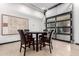 A circular dining table with leather chairs is set near the glass garage doors at 2242 E Palm Ln, Phoenix, AZ 85006