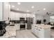 Bright kitchen with white cabinets, stainless steel appliances, granite counters, and island with seating at 2242 E Palm Ln, Phoenix, AZ 85006