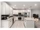 Modern kitchen with white cabinetry, stainless steel appliances, granite countertops, and spacious center island at 2242 E Palm Ln, Phoenix, AZ 85006