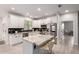 Bright kitchen with white cabinets, stainless steel appliances, granite counters, and island with seating at 2242 E Palm Ln, Phoenix, AZ 85006