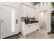 Garage conversion featuring a kitchenette with white cabinets and granite counters at 2242 E Palm Ln, Phoenix, AZ 85006