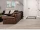 Cozy living room with leather furniture, light wood floors, and a neutral color scheme at 2242 E Palm Ln, Phoenix, AZ 85006