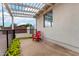 Relaxing outdoor patio area featuring a stylish pergola, a comfortable red chair, and lush greenery at 2242 E Palm Ln, Phoenix, AZ 85006