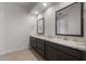 Bathroom with dual sinks, granite countertop, dark cabinetry, and tile flooring at 22523 E Orchard Ln, Queen Creek, AZ 85142