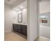 Bathroom with dual sinks, granite countertop, dark cabinetry, and tile flooring at 22523 E Orchard Ln, Queen Creek, AZ 85142