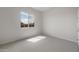 Bright bedroom features a window, neutral carpet and neutral paint at 22523 E Orchard Ln, Queen Creek, AZ 85142