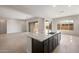 Open kitchen features a large center island with dark cabinetry and granite countertop at 22523 E Orchard Ln, Queen Creek, AZ 85142