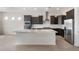 Stylish kitchen boasting stainless steel appliances, dark cabinets, and a large island at 22523 E Orchard Ln, Queen Creek, AZ 85142