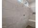 Stylish tiled shower with built-in bench, niche, and gray hexagon floor tile at 22523 E Orchard Ln, Queen Creek, AZ 85142